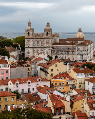 View of the old town with colorful houses and the impressive architecture of a church by the water.