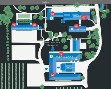 Labeled site map showing the layout of a complex, including buildings such as the Main Building, Forum, and various amenities, with pathways and green spaces indicated.
Map overview of the arrangement of a complex, including buildings like the Main Building, Forum, and various amenities, with pathways and green areas.